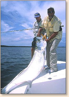 Capt. Paul Dixon, happy client and tarpon