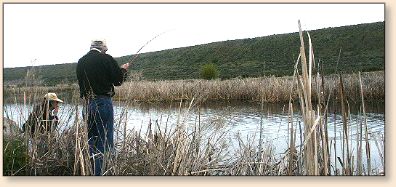 JC playing trout, LadyFisher
 with the net